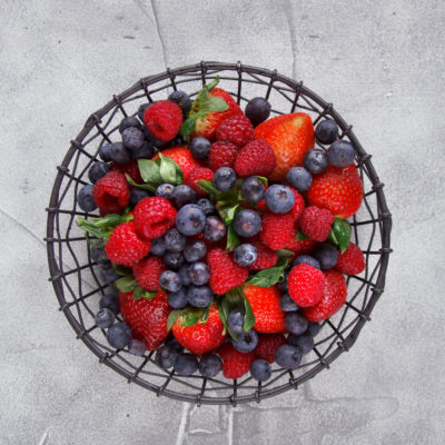 Berry Mix, Blueberries, Raspberries And Strawberries Close Up On A Gray Background