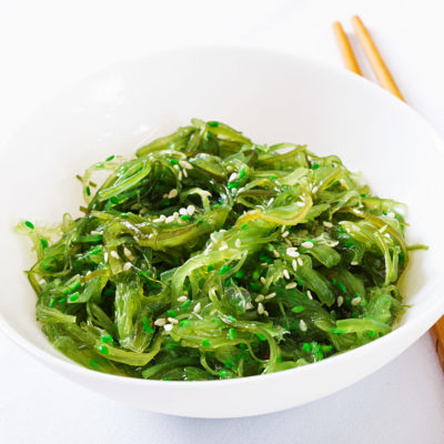 Wakame Chuka Or Seaweed Salad With Sesame Seeds In Bowl On White Background
